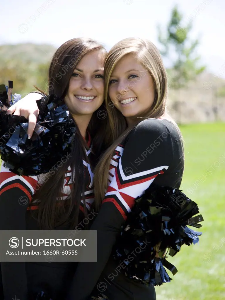 USA, Utah, American Fork, Portrait of two cheerleaders hugging