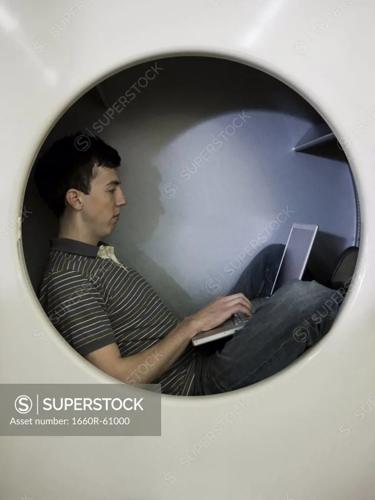 man inside a commercial clothes dryer at a laundromat