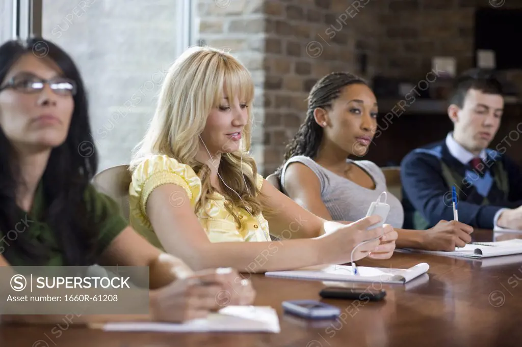 woman using her cell phone during a meeting