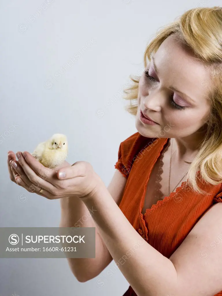 woman holding a baby chick