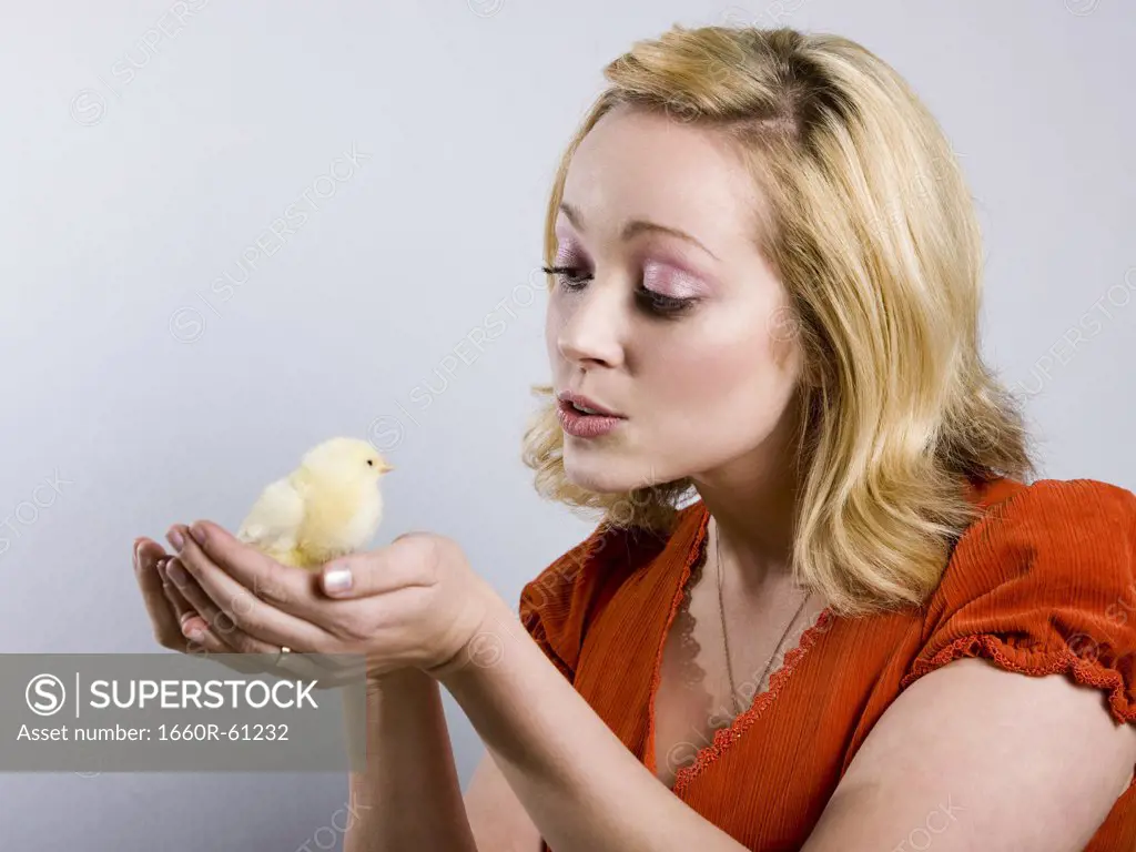 woman holding a baby chick