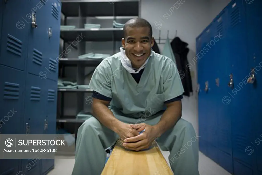Portrait of a male doctor sitting on a bench
