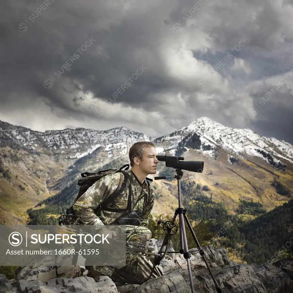 hunter using binoculars to spot prey