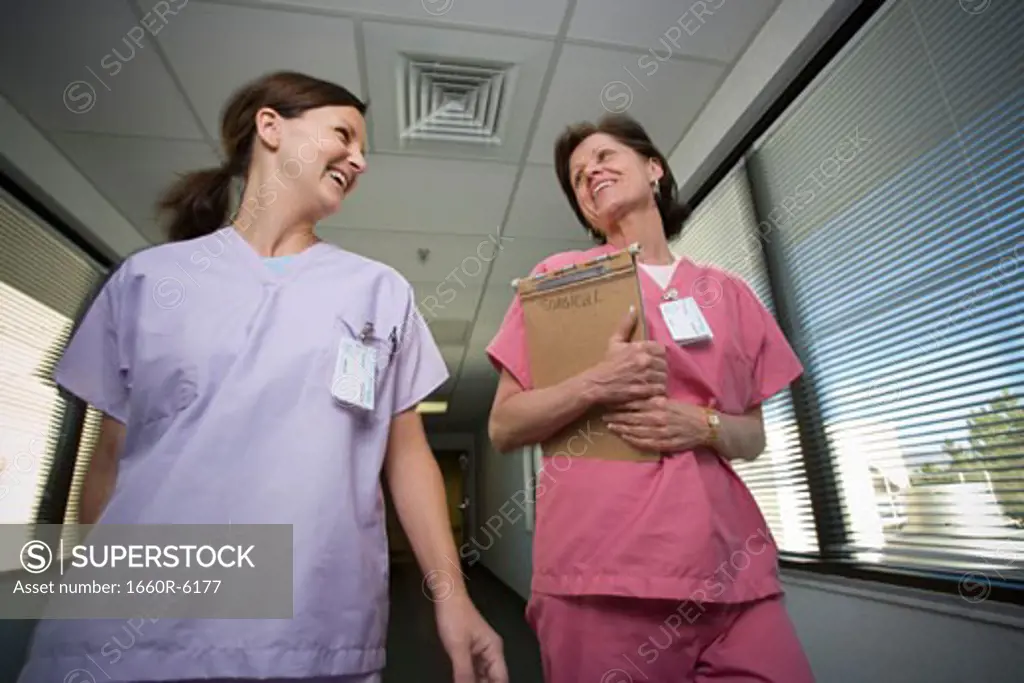 Close-up of two female nurses walking in a corridor