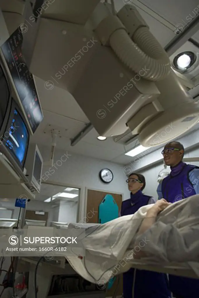 Low angle view of two doctors examining a patient