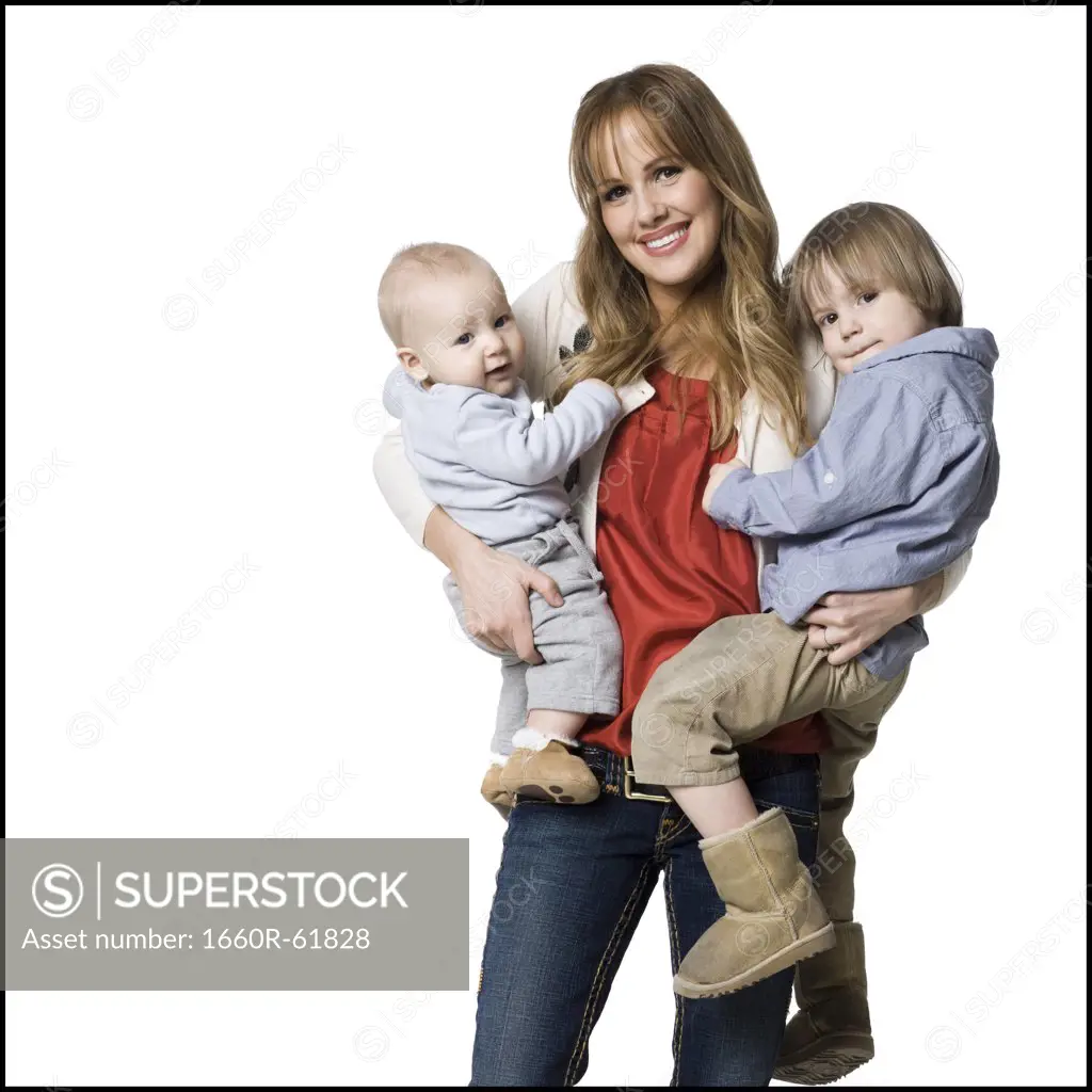 woman holding two children