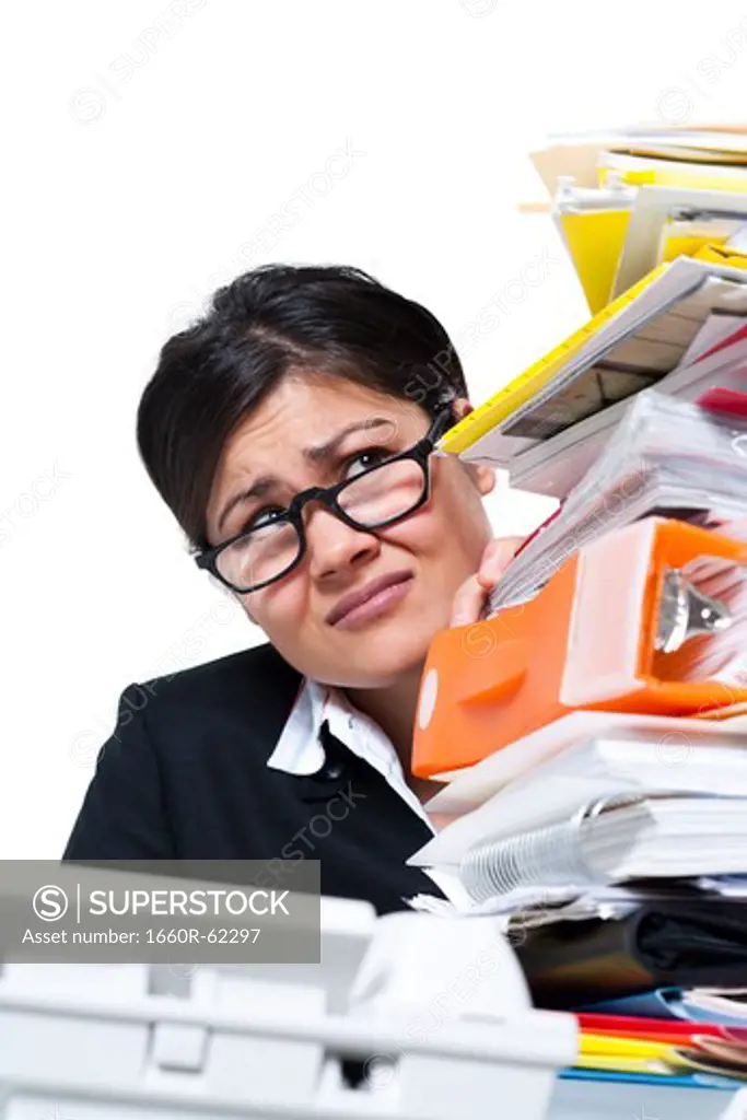 Woman with stack of binders and paperwork