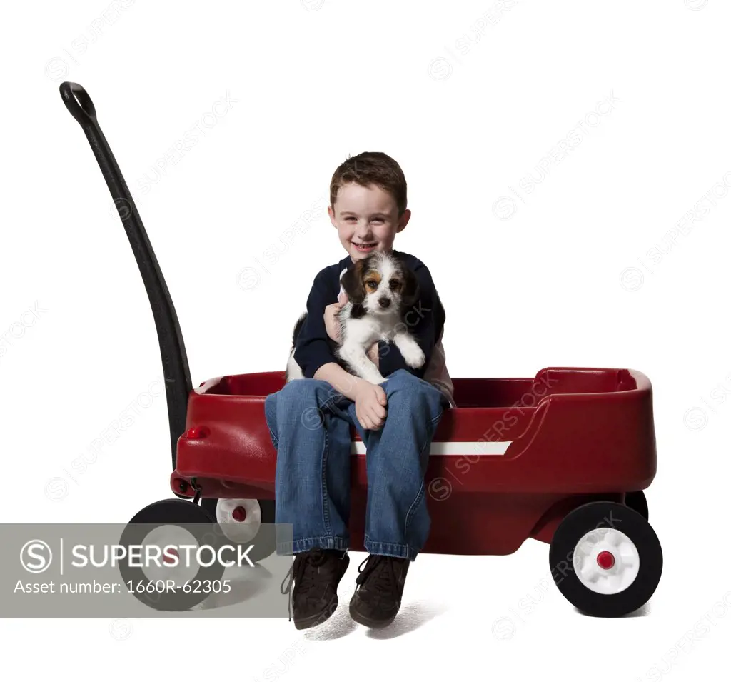 Boy with puppy and toy wagon