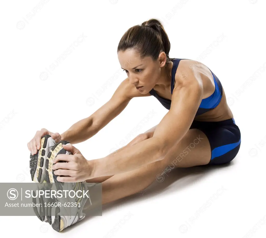 Woman athlete stretching legs