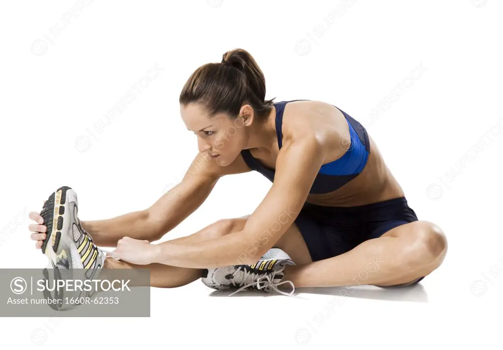 Woman athlete stretching legs