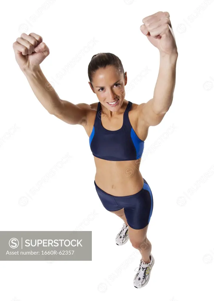 Woman athlete holding medal and making hand gesture