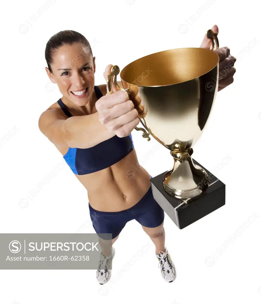 Woman athlete holding medal and making hand gesture