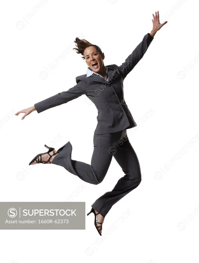 Businesswoman jumping with arms raised