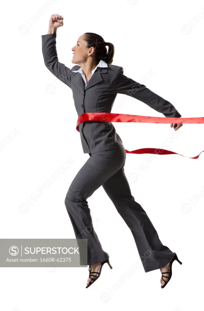 Businesswoman crossing finish line