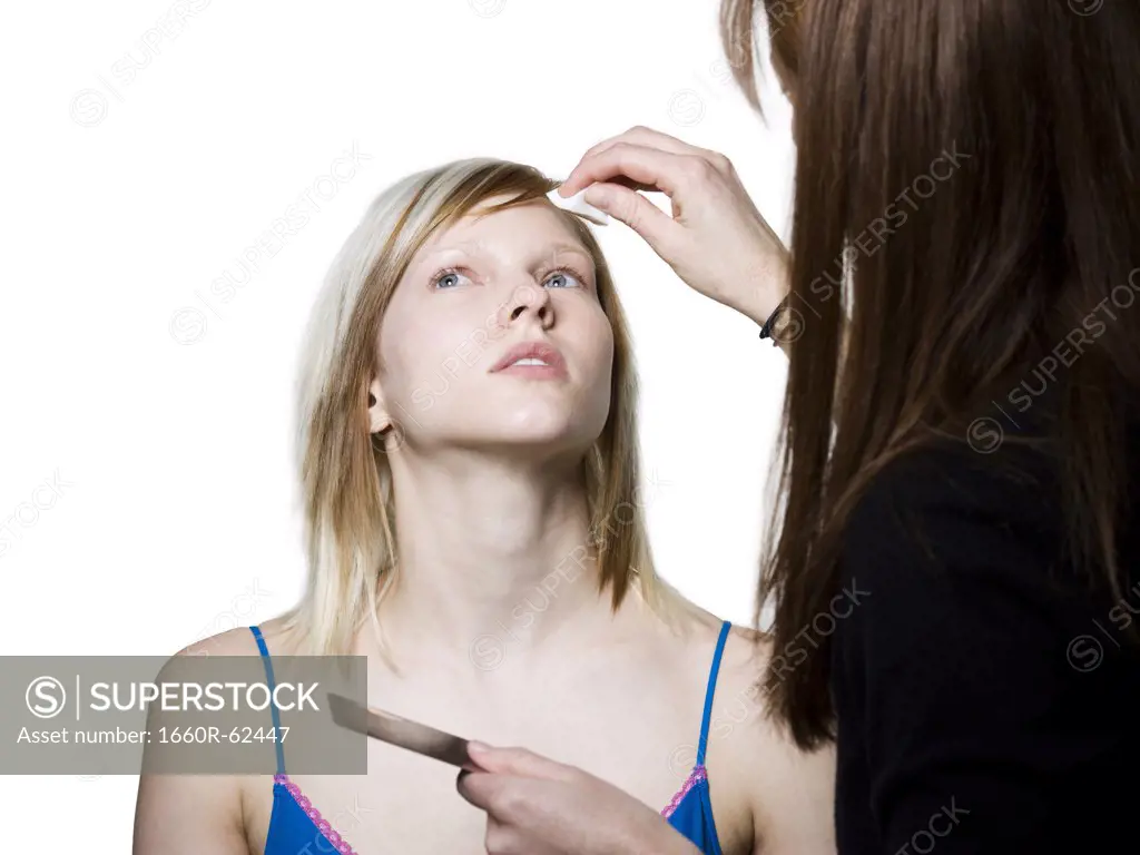 Woman receiving cosmetic application
