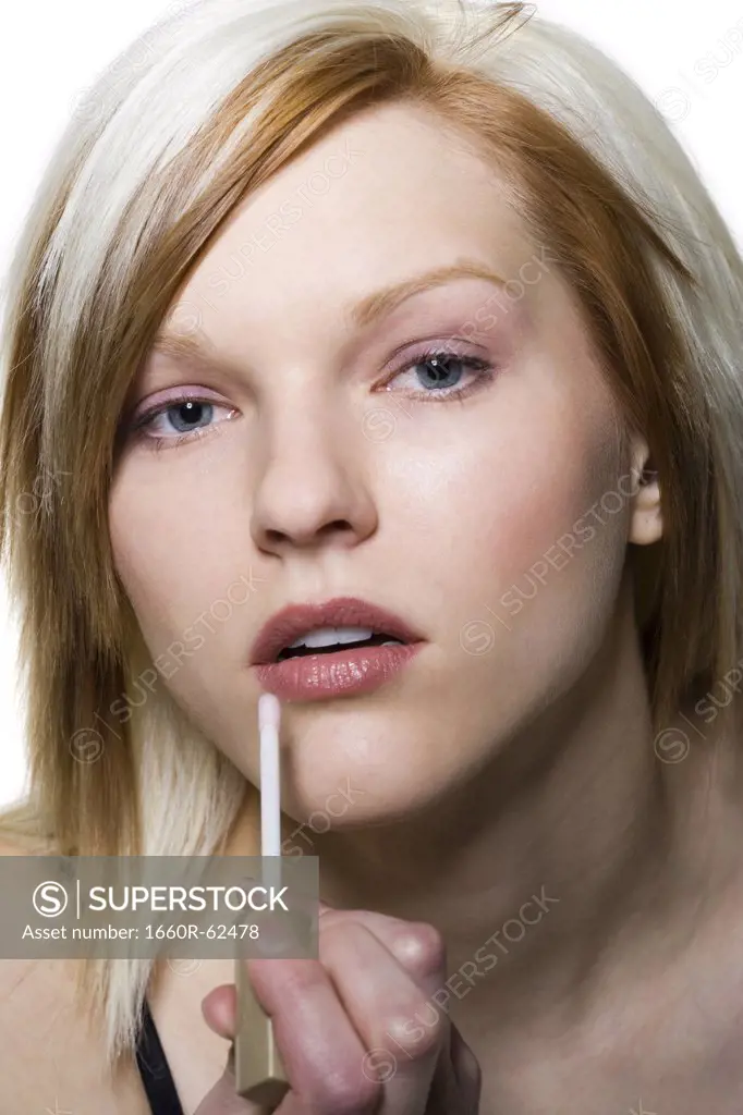 Woman applying cosmetics