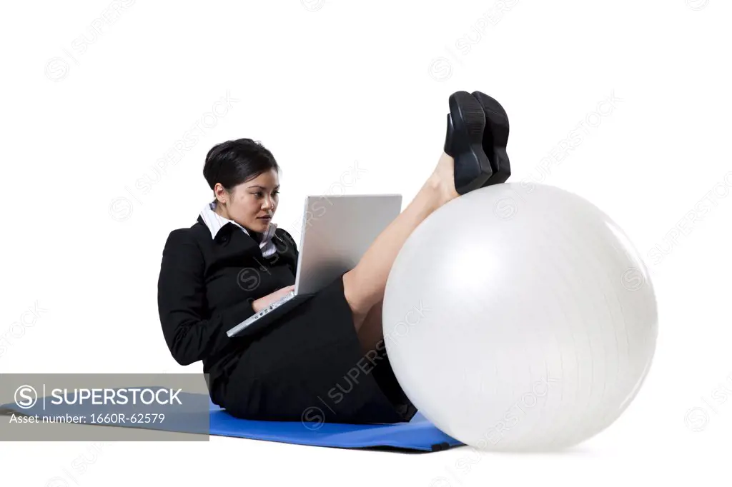 Woman doing yoga with laptop