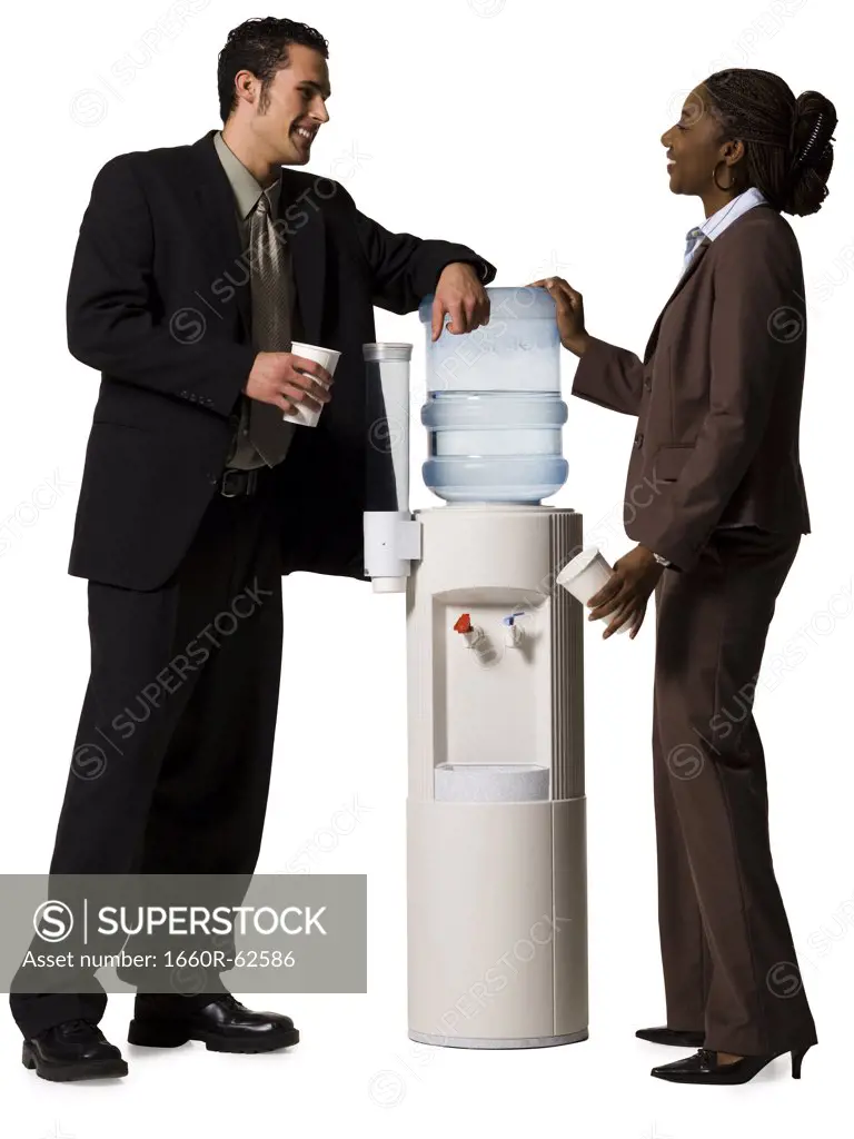 Business people conversing at water cooler
