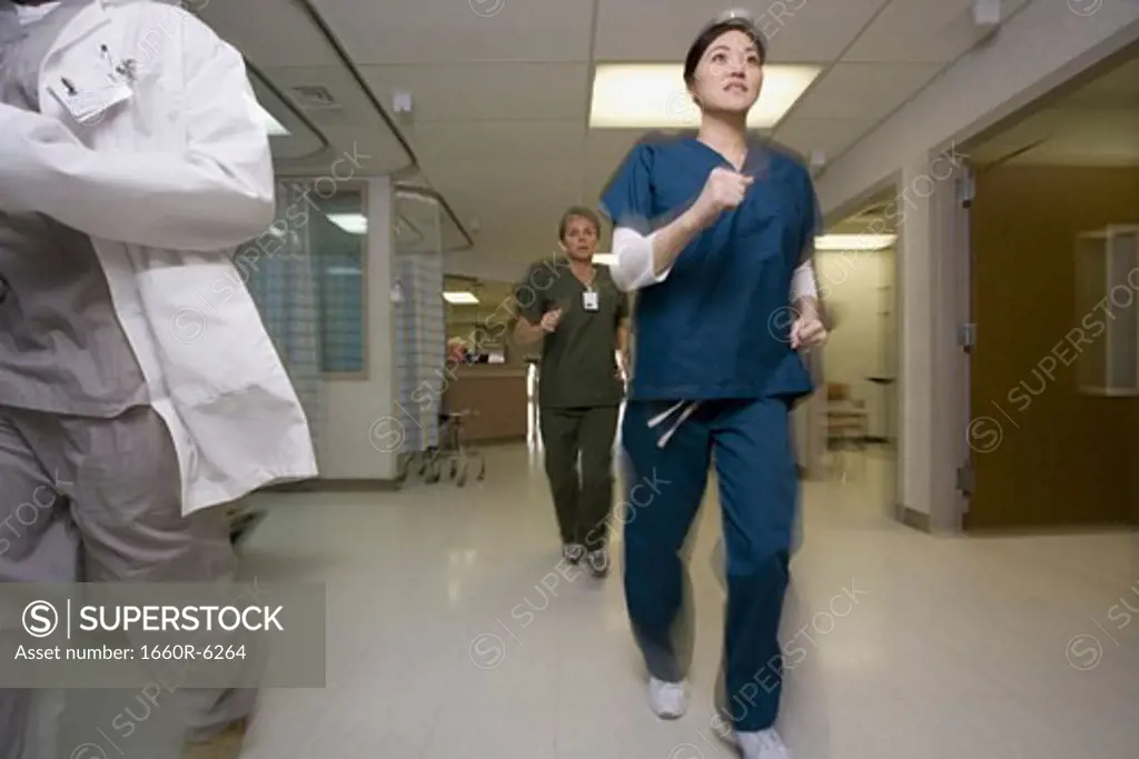 Low angle view of three doctors running