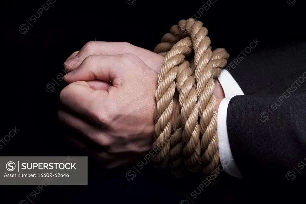 Hands tied at the wrists with rope