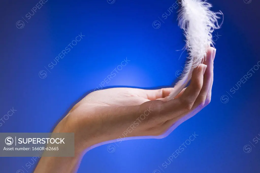 Hand with floating feather