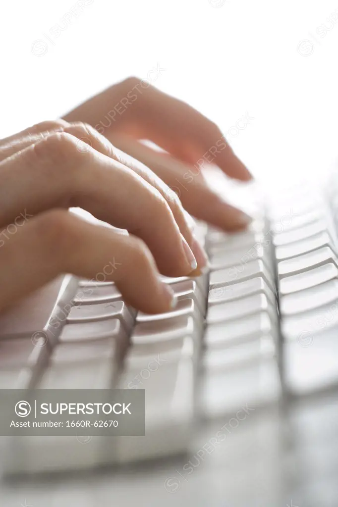 Close-up of fingers typing on keyboard