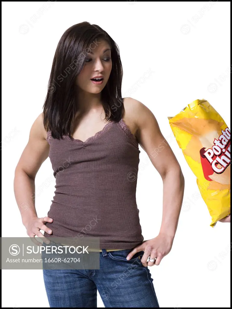 Woman tempted by potato chips