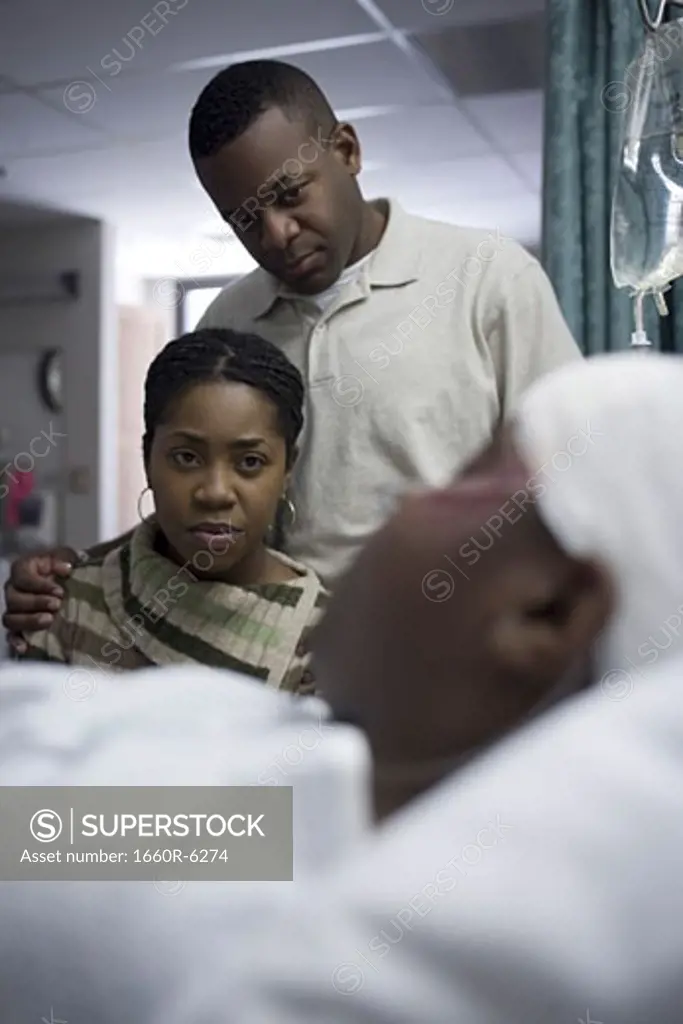 Parents looking at their teenage son in the hospital