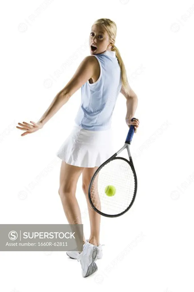 Tennis player hitting ball