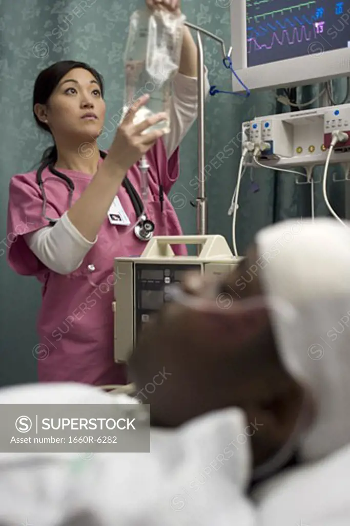 Female nurse checking an intravenous drip