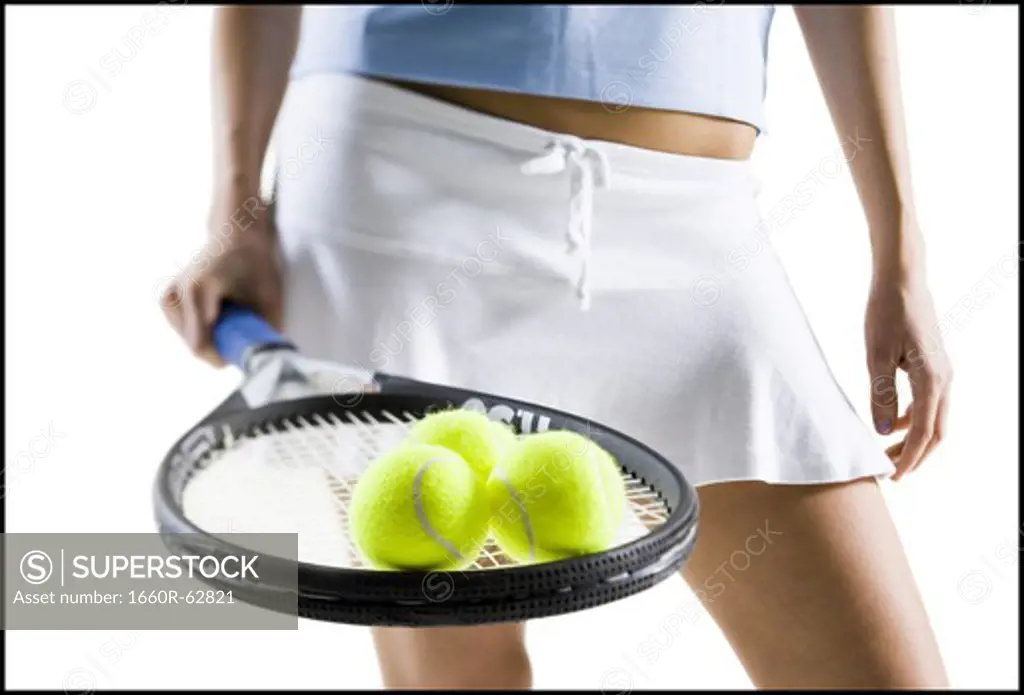 Close-up of tennis player with racket and balls