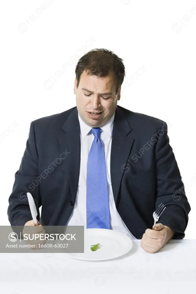 Overweight businessman eating a small salad