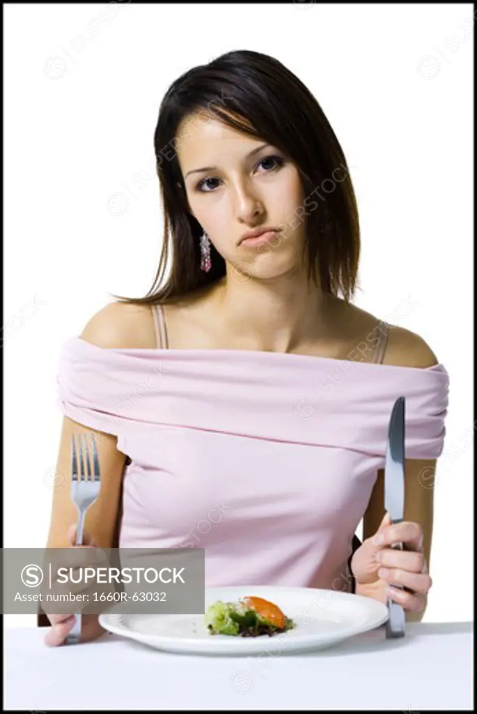 Woman on a diet eating a small salad