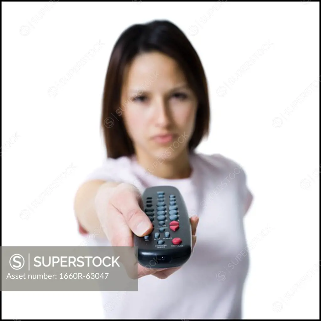 Woman pointing and pressing a handheld remote control