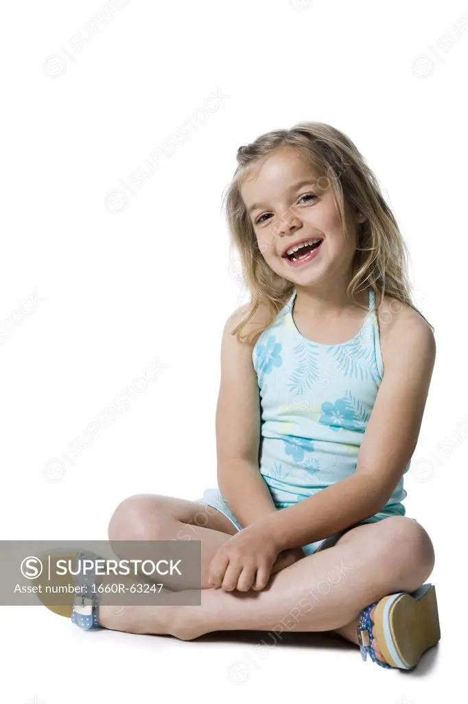 Young girl posing and sitting cross legged