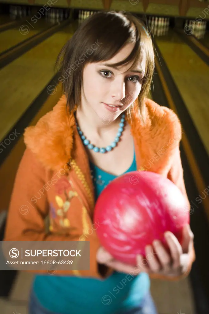 Portrait of a teenage girl holding a bowling ball