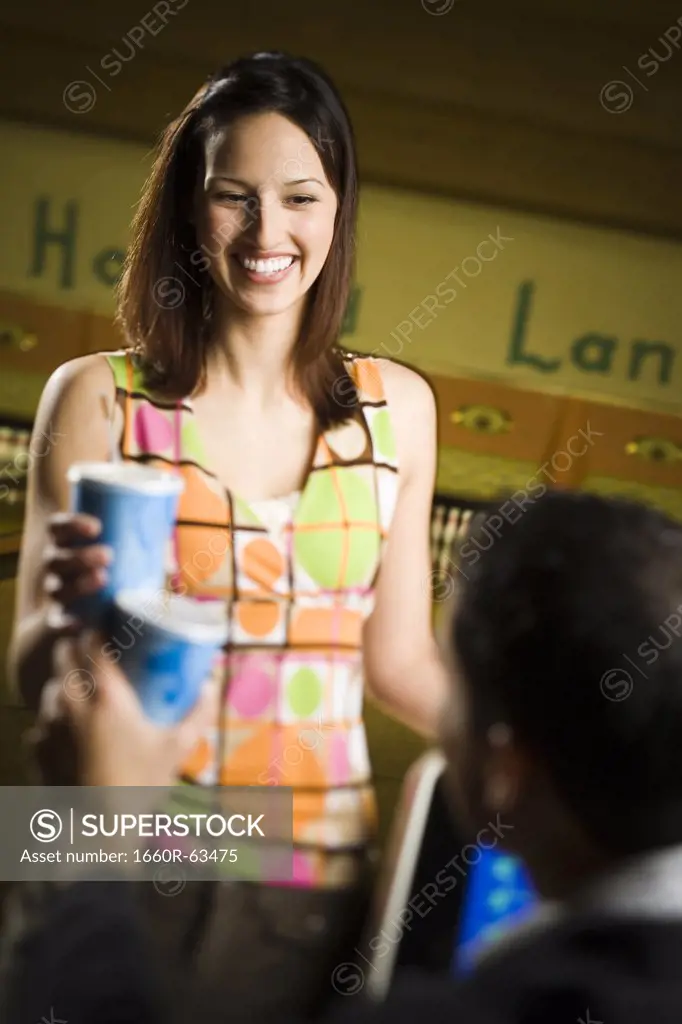 Teenage girl looking at a young man and smiling