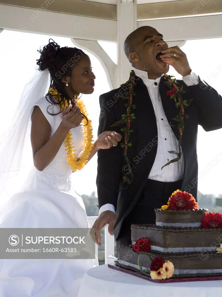 Bride and groom eating their wedding cake