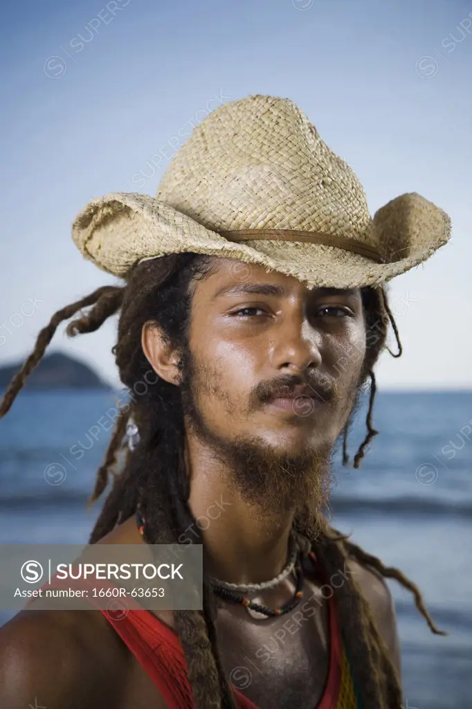 Portrait of a young man wearing a straw hat