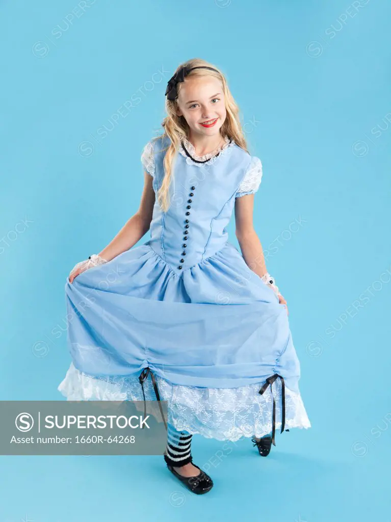 Portrait of girl (10-11) in Alice in Wonderland costume for Halloween