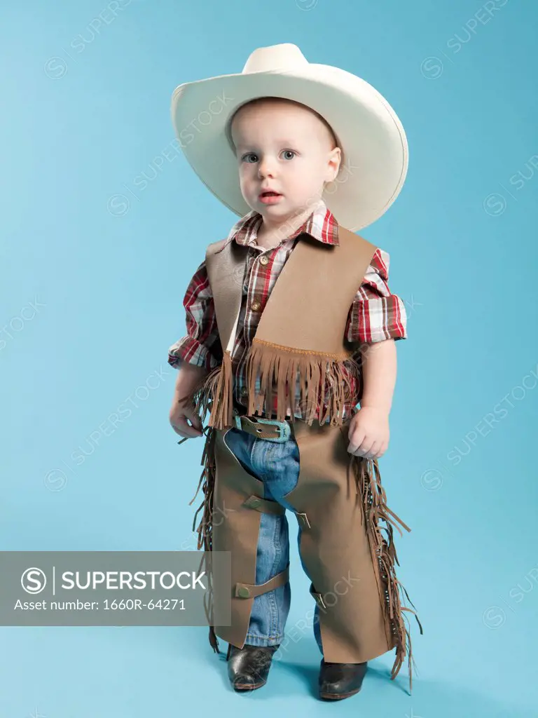 Portrait of boy (12-17 months) in cowboy costume for Halloween