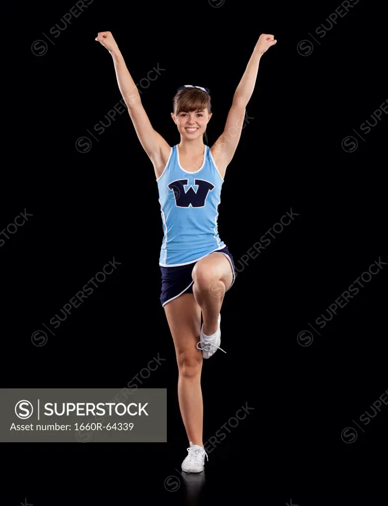 Portrait of teenage cheerleader girl (16-17) stretching