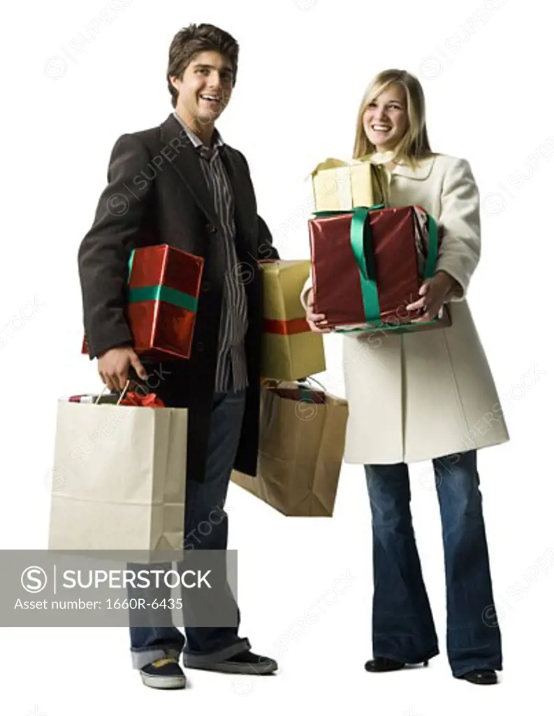Portrait of a young couple holding gifts and shopping bags