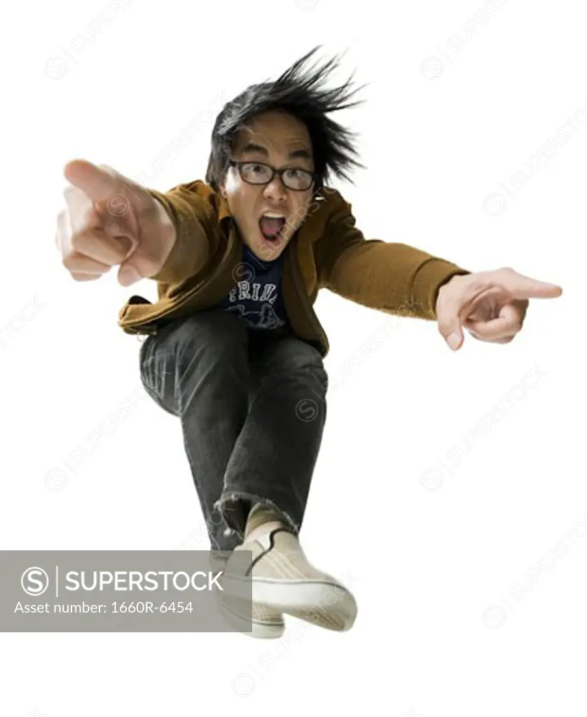 Portrait of a young man jumping and pointing