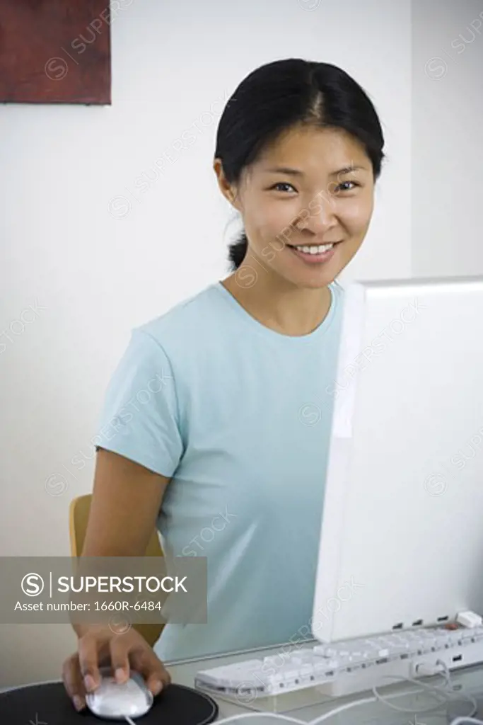 Portrait of a mid adult woman sitting in front of a computer