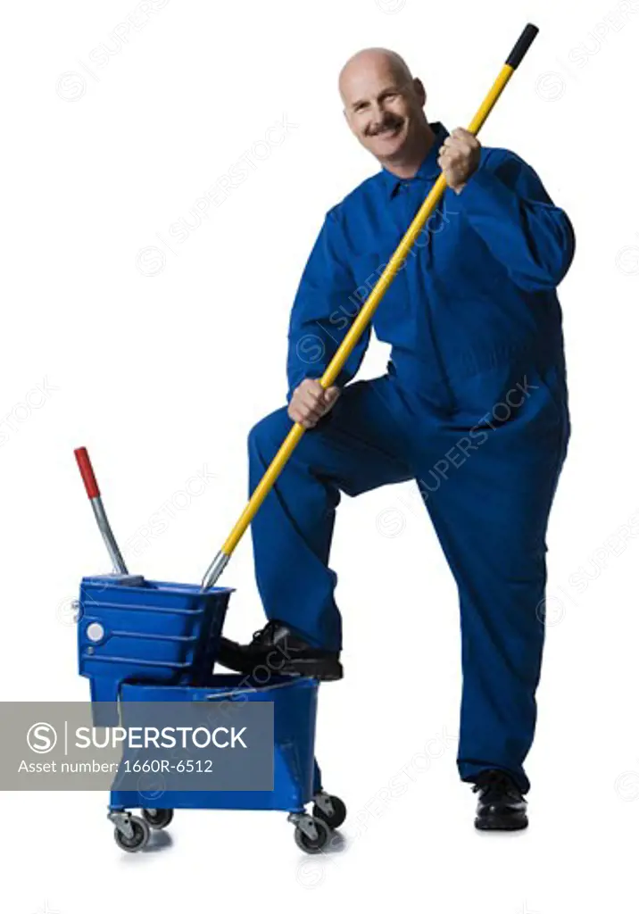 Portrait of a male janitor holding a mop