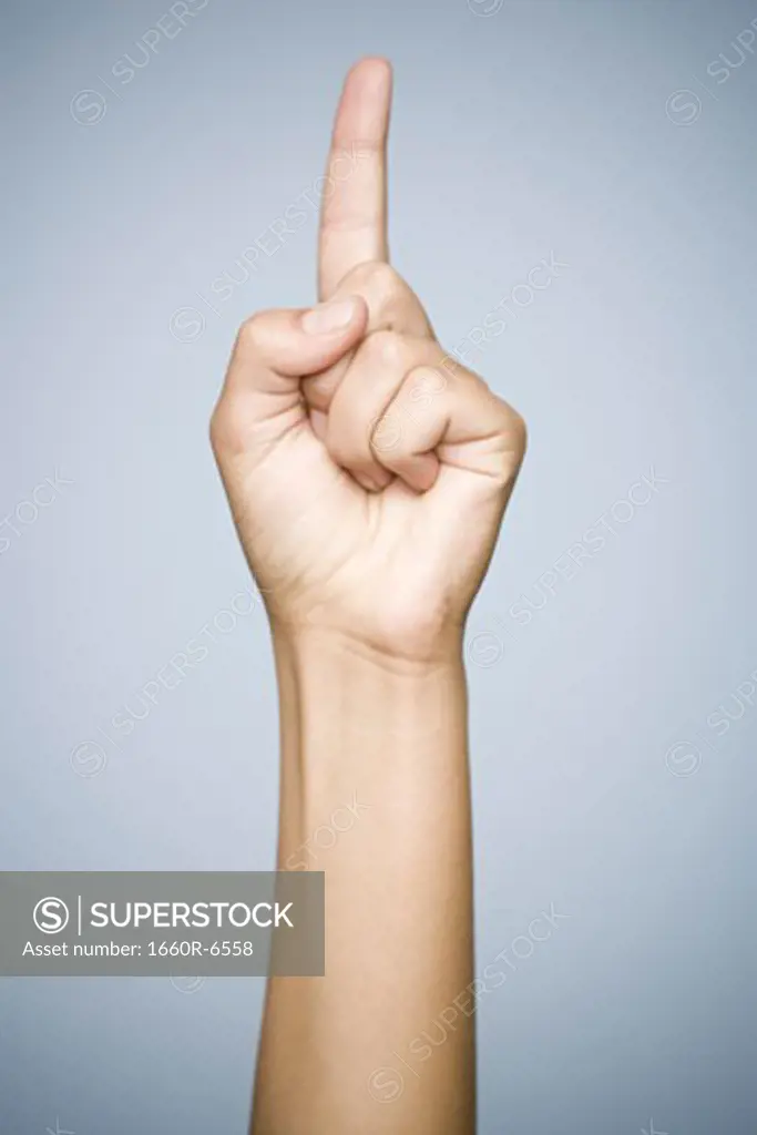Close-up of a person's finger pointing up; sign language for the number one