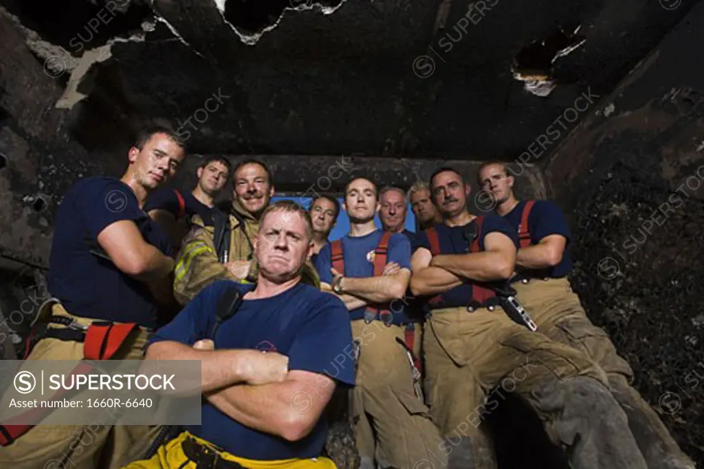 Low angle view of a group of firefighters with arms crossed