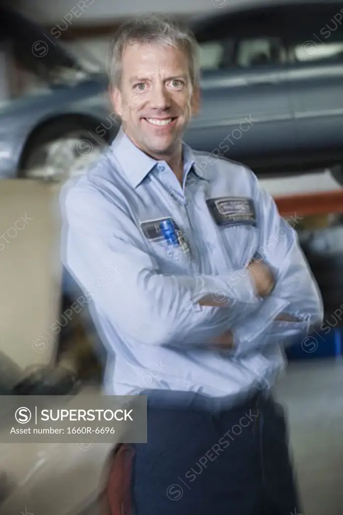 Portrait of a mechanic standing with his arms crossed