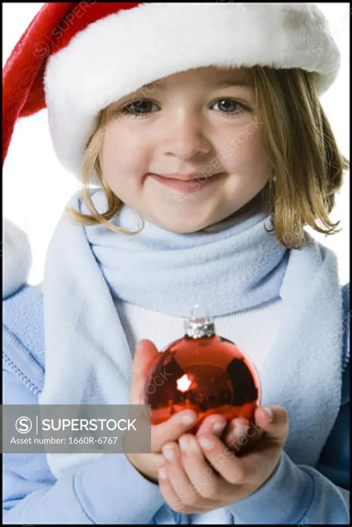 Portrait of a girl holding a Christmas ball